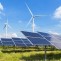 Wind turbines and solar panels beneath a clear blue sky